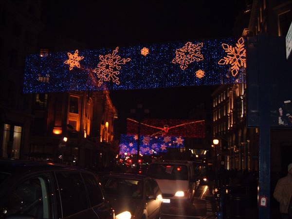 Christmas snowflake lights strung above Regent Street, night traffic