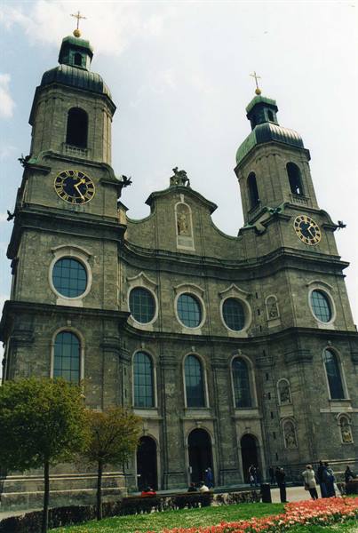St. James Cathedral in Innsbruck, baroque facade with green towers and flowers