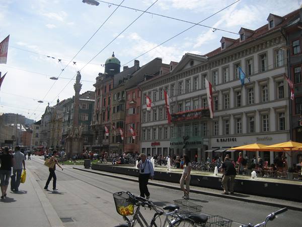 Maria-Theresien-Straße in Innsbruck, bicycles and pedestrians in front of colorful buildings