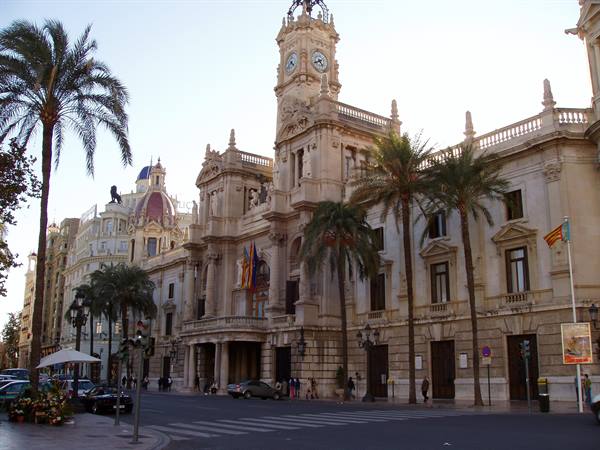 Valencia City Hall on Plaza del Ayuntamiento, ornate facade with clock tower and palm trees