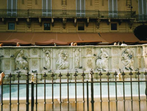 Fonte Gaia in Siena, carved marble panels behind black railing
