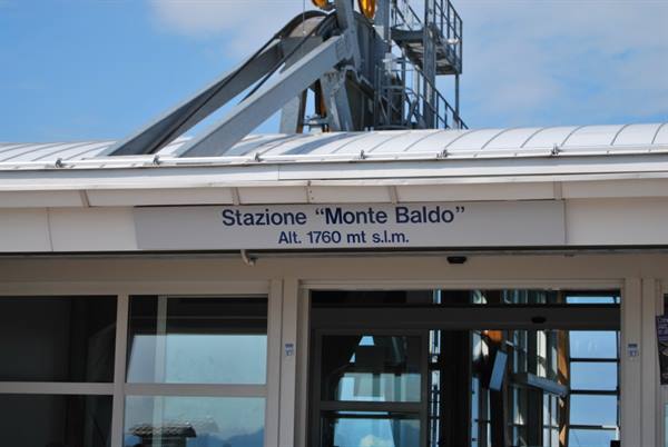 Monte Baldo cable car station sign, 1760 meters, metal roof and cable structure