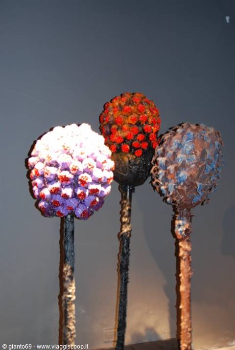 Spherical sculptures made of colorful sweets on stems, indoors exhibition