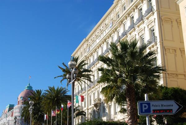 Palm tree in front of the Hotel West End facade, Place Massena parking sign
