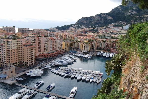 Motor yachts moored at Fontvieille marina, Monaco, under cliffs