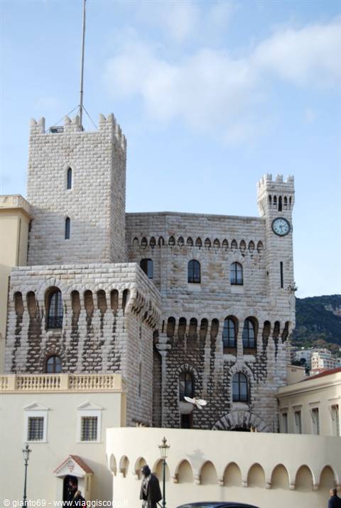 Prince's Palace of Monaco, crenellated stone towers with clock, blue sky