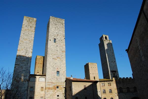 Medieval stone towers of San Gimignano against a clear blue sky
