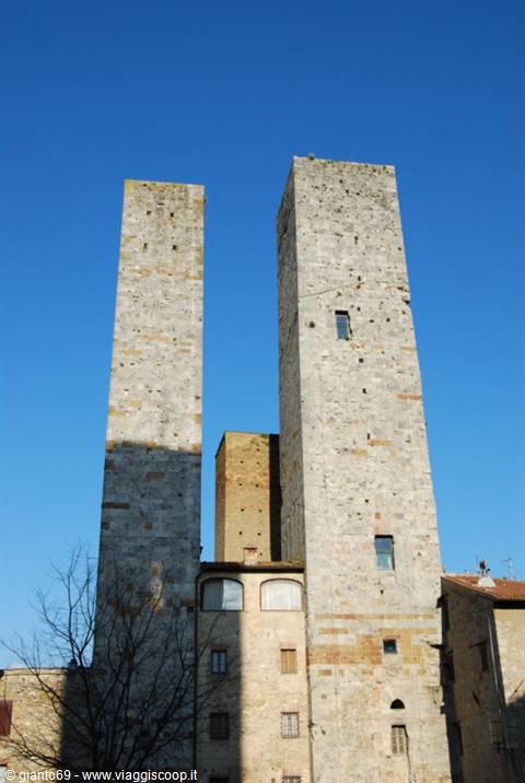 The medieval stone towers of San Gimignano against a blue sky
