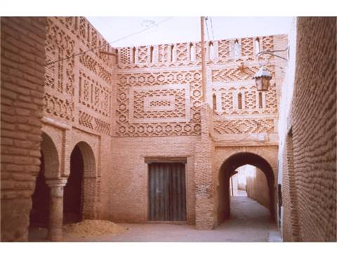 Decorated brick walls and arches in a Tozeur alley