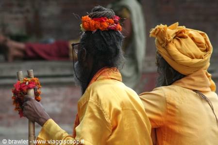 Two sadhus in yellow turbans with orange marigold flowers, Pashupatinath
