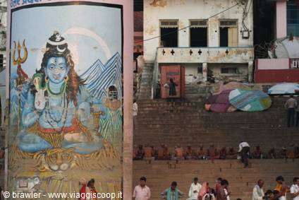 Shiva mural on the Varanasi ghats, people seated on the stone steps