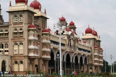 Mysore Palace facade with red domes and arches under overcast light