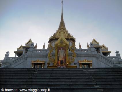 Marble staircase of Wat Traimit with golden gate and king's portrait