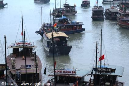 Wooden boats with red flags anchored in Ha Long Bay