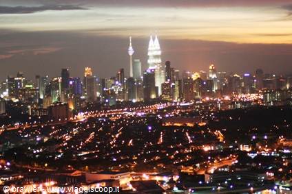 Kuala Lumpur illuminated skyscrapers with Petronas Towers at dusk