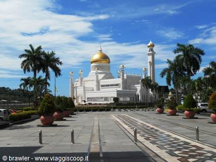 Omar Ali Saifuddien Mosque with golden dome among palms and marble walkways