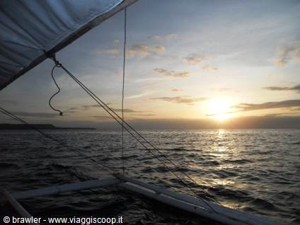 Sail and rigging cables of a boat over the sea at sunset