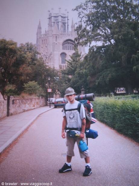 Young backpacker with a large pack outside Ely Cathedral