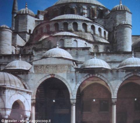 Arcades and domes of the Blue Mosque in Istanbul under blue sky