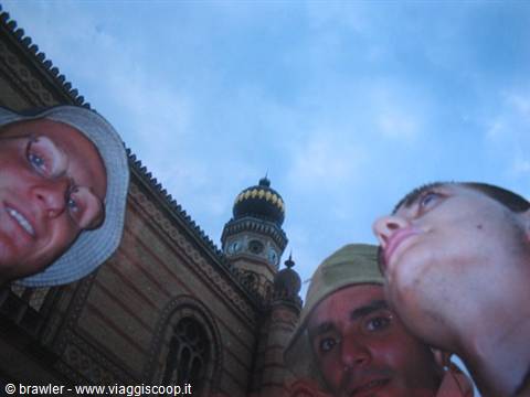 Three friends looking up beside a synagogue with an ornate dome