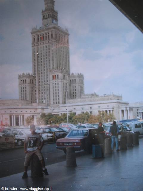 Boy leaning on a bollard in front of the Palace of Culture and Science
