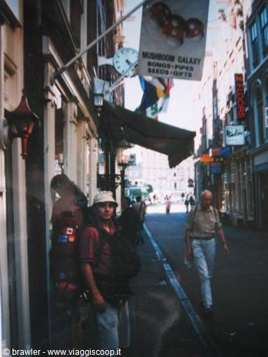 Backpacker on an Amsterdam street, Mushroom Galaxy sign overhead