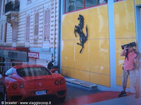 Red Ferrari parked outside the yellow prancing horse storefront