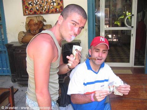 Two tourists with cigars and banknotes inside a local eatery
