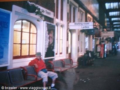 Man in red jacket sitting in Trent station waiting room