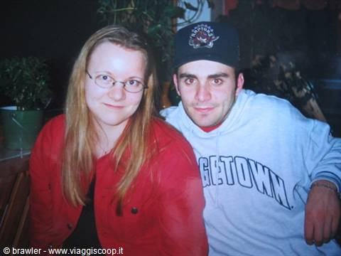 Blonde girl with glasses and red jacket next to guy in Georgetown sweatshirt and cap