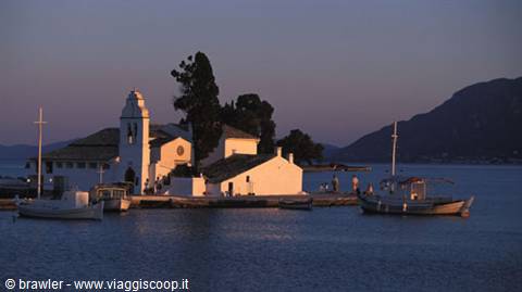 Vlacherna Monastery in Corfu, boats moored on calm waters at dusk