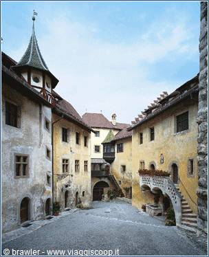 Inner courtyard of Runkelstein Castle with oriel tower and stone staircases