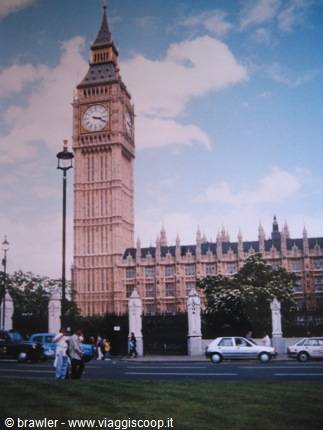 Tourists walk past Big Ben and the Houses of Parliament in London