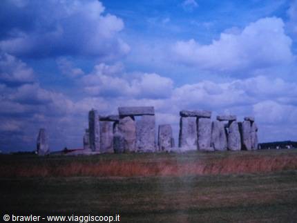 Stonehenge megalithic stones under a sky of white clouds