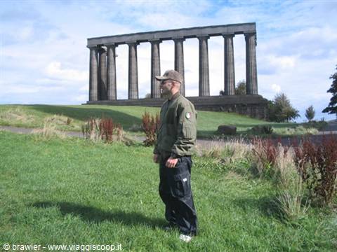 Tourist standing on the grass in front of the National Monument on Calton Hill, Edinburgh