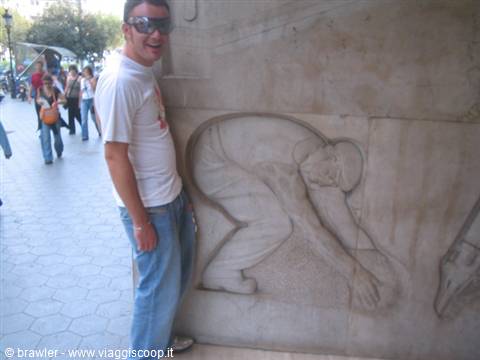 Smiling man next to a marble relief sculpture on La Rambla