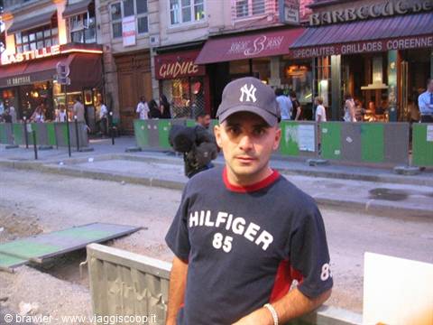 Man in Yankees cap in front of bars at Place de la Bastille