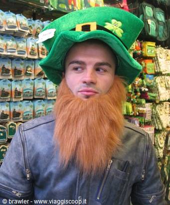 Tourist wearing a green leprechaun hat and fake red beard in a souvenir shop