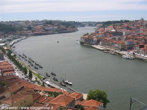 Douro river in Porto with rabelo boats and red-roofed houses