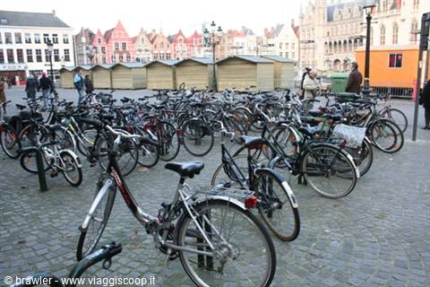 Bicycle racks on the Markt square in Bruges, among wooden market stalls