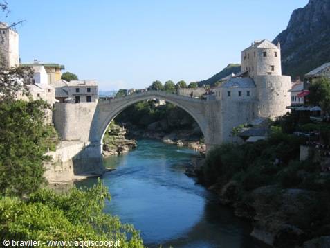 Mostar's stone arch bridge crosses the Neretva river in sunlight