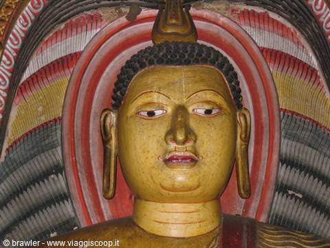 Golden painted Buddha face inside Dambulla rock temple