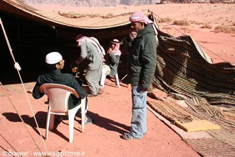 Bedouin men under a black goat-hair tent in Wadi Rum desert