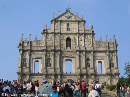 Stone facade of the Ruins of St. Paul's in Macau, tourists crowd the steps