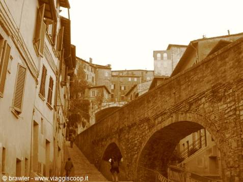 Steep alley with old houses and medieval stone aqueduct, Perugia