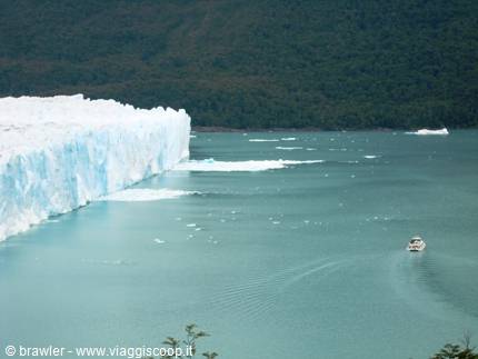 Perito Moreno Glacier: blue ice wall over the lake, boat sailing by