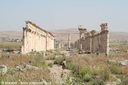 Children walk along the great ancient colonnade of Apamea