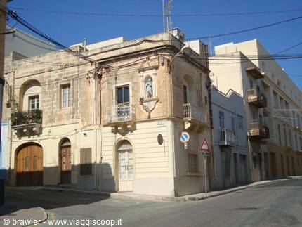 Maltese street corner with a statue niche on a limestone building