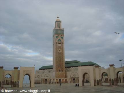 Stone arcades and the tall minaret of Hassan II Mosque in Casablanca
