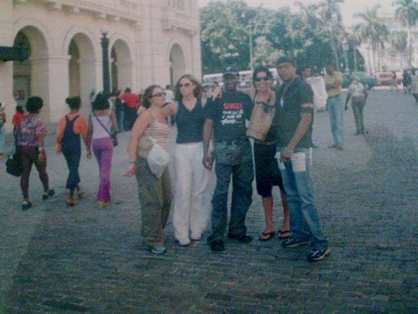 Group of friends posing on cobblestones in front of arcaded building